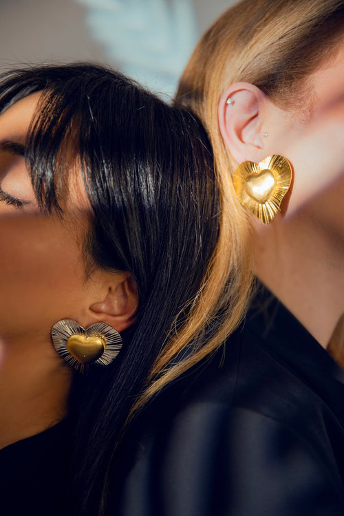 A l'Amour heart earrings worn in gold and in gold inside silver