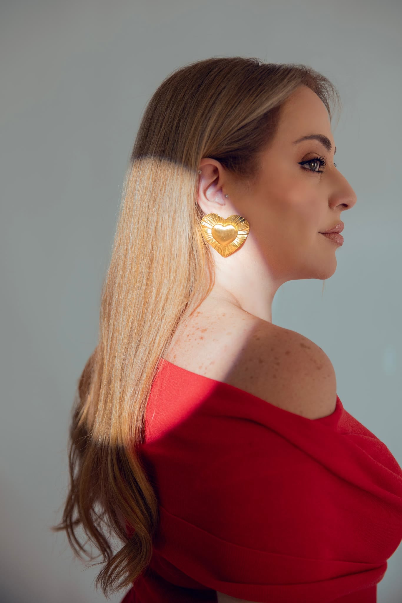 A l'Amour heart earring worn in profile