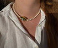 Eternelle pearl necklace with a gold charm, worn with linen