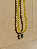 Poisson bleu necklace with yellow cat eye beads and enamel fish charm