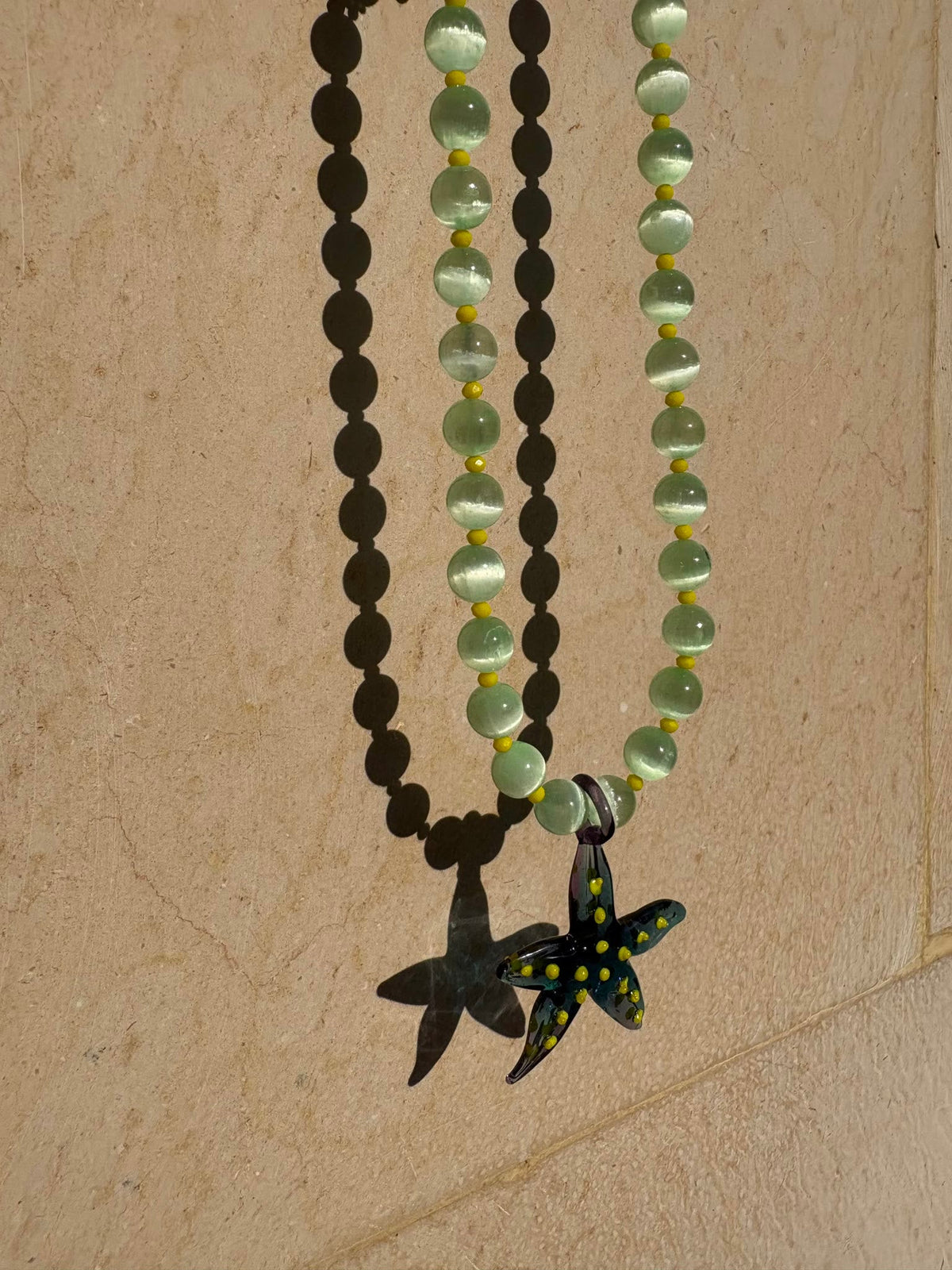 Starfish necklace with a hand-painted dark green glass starfish
